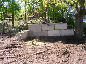 CONCRETE BINS INSTALLED TO CONTAIN TOPSOIL AND MULCH