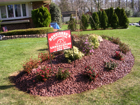 RAISED BURGANDY STONE ISLAND AND PLANTING DESIGN