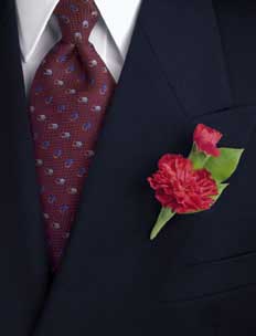 This boutonniere consists of one stem of red mini carnation 	and one stem salal.