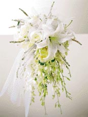 bouquet contains flowers such as queen anne's lace, stargazer lily, roses, 	dendrobium	orchid and cream tulle