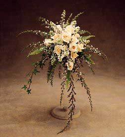 bouquet contains flowers such as sterling range heather, ivory 	roses, champagne sweetheart roses, white lilac and delicate greens