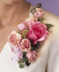 This corsage contains flowers such as one pink rose, pink 	spray roses, eucalyptus and pink satin ribbon.