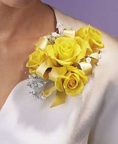 This corsage contains flowers such as four yellow sweetheart 	roses, gypsophilia and yellow satin ribbon. 