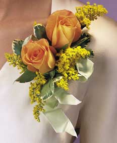 This corsage contains flowers such as yellow and peach roses, 	solidaster, variegated ivy and mint green satin ribbon. 