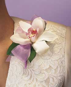 This corsage contains flowers such as white cymbidium orchid, 	salal and pink sheer ribbon.