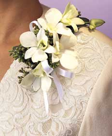 This corsage contains flowers such as white dendrobium 	orchids, eucalyptus and white satin bridal ribbon.