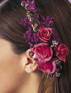 This hair piece contains flowers such as pink spray roses, 	lavender statice and heather.