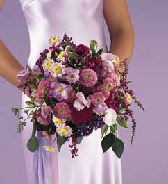 bouquet with lavender sweet pea, lavender pompons, dark purple 	mini carnations, lavender freesia, 	lavender delphinium, lavender 	daisy pompons, heather, limonium, statice. eucalyptus 