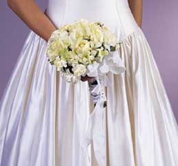 contains flowers such as white and cream textured 
		roses, white orchids, white carnations  white mini carnations 		and variegatged greens