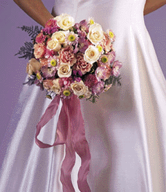 pink roses, and burgundy lilies.  This  bouquet is softened 	with plumosis fern and dried pink gypsophllia.