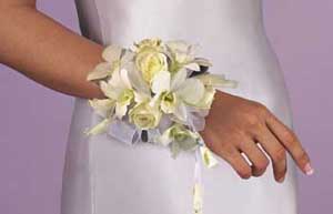This corsage consists of one stem of white dendrobium orchids, 	5 white sweetheart roses and white chiffon ribbon.