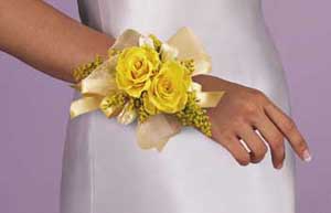 This corsage consists of 2 yellow roses 3 white sweeheart 	roses, solidaster, yellow chiffon ribbon and yellow satin ribbon.